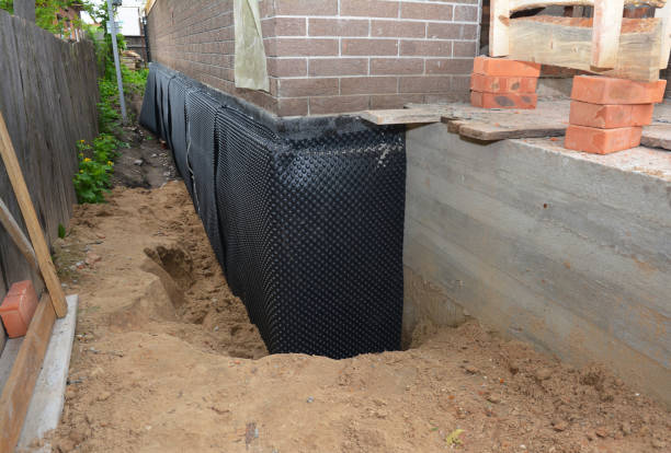 Happy homeowners after waterproofing job in Atlas
